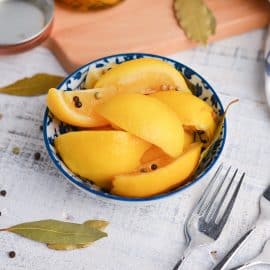 angled shot of preserved lemons in a blue bowl