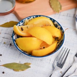 angled shot of preserved lemons in a blue bowl