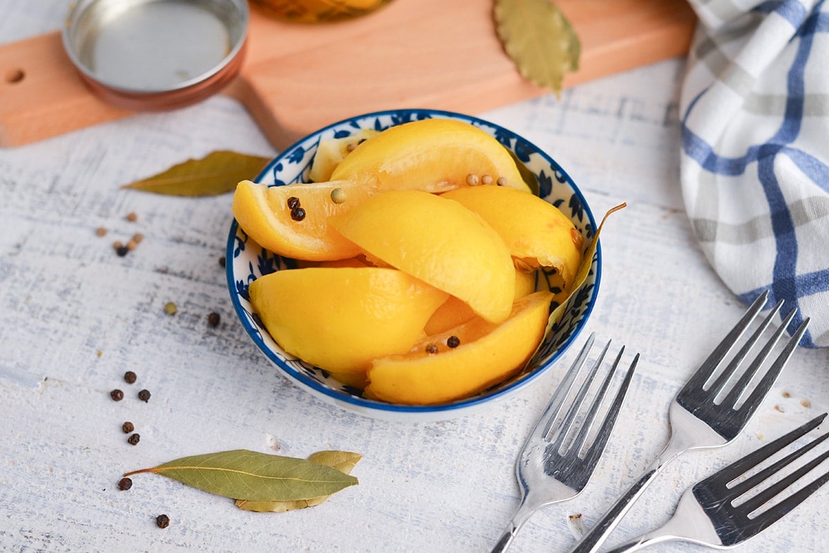 angled shot of preserved lemons in a blue bowl