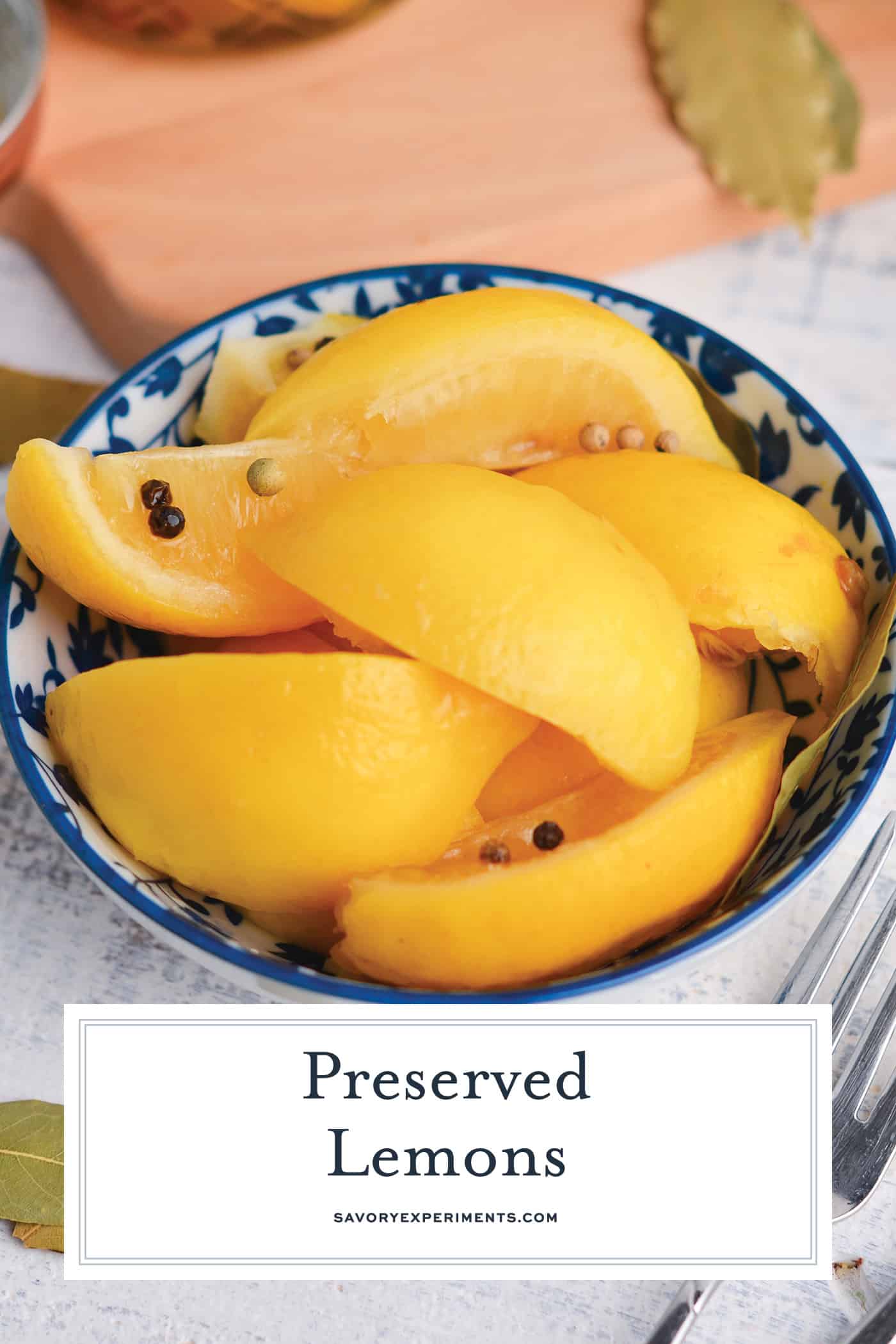 angled shot of preserved lemons in a blue bowl with text overlay for pinterest
