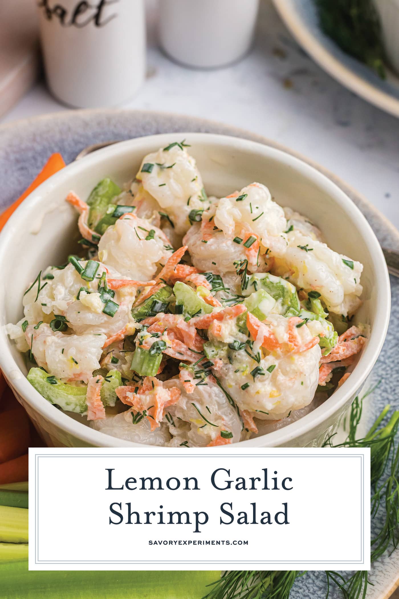 angled shot of bowl of lemon garlic shrimp salad with text overlay for pinterest