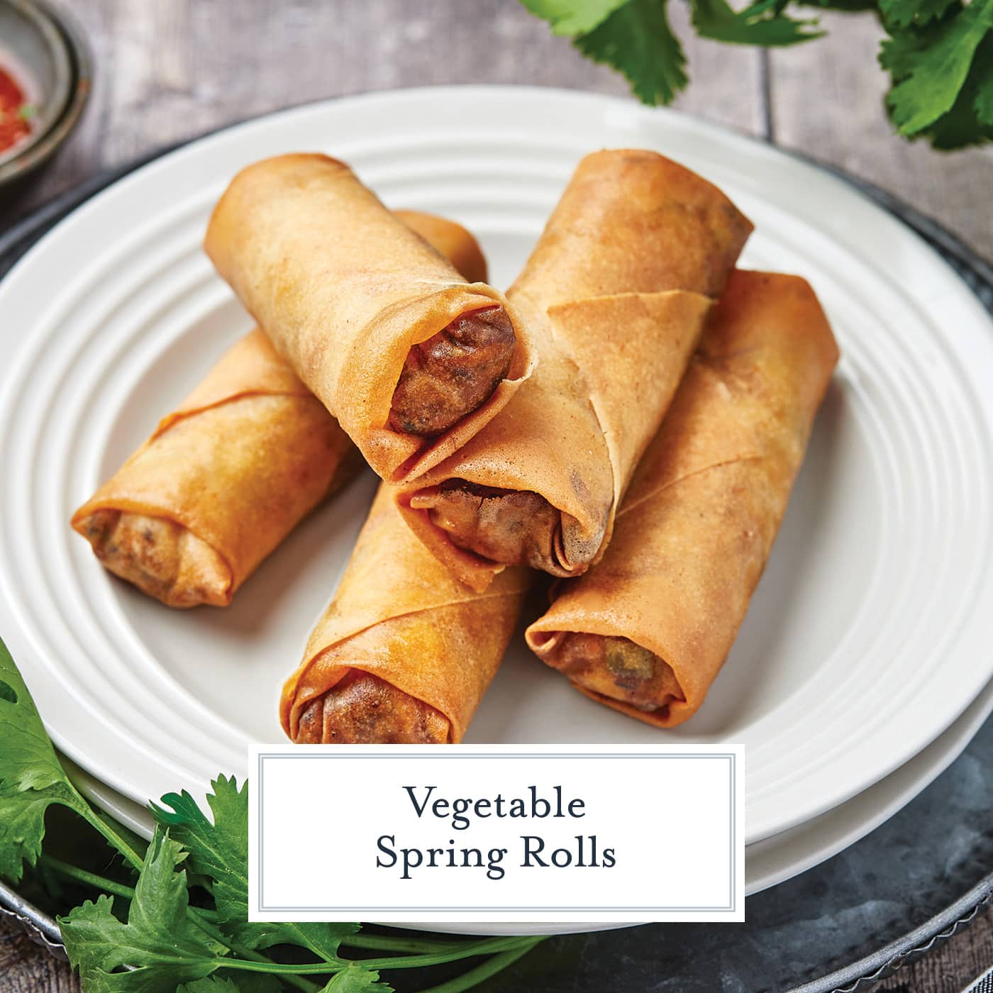 pile of spring rolls on a plate with text overlay for facebook