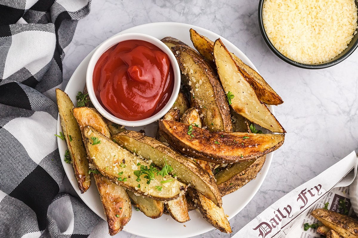 overhead shot of plate of truffle fries with bowl of ketchup