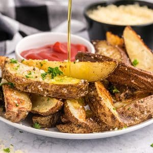 oil poured onto plate of truffle fries