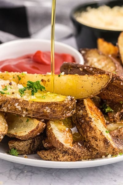 oil poured onto plate of truffle fries