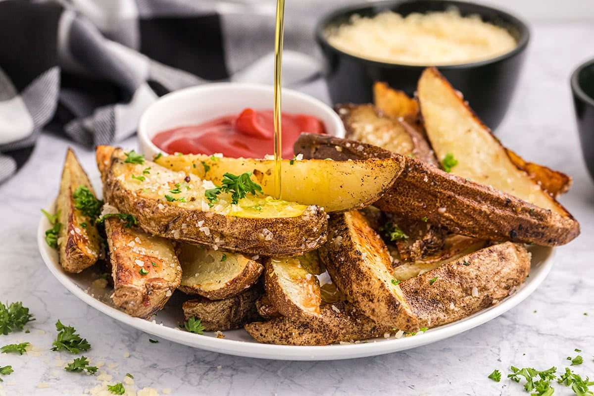 oil poured onto plate of truffle fries