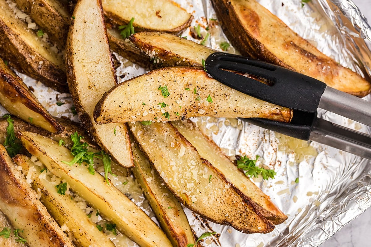 tongs holding one truffle fry