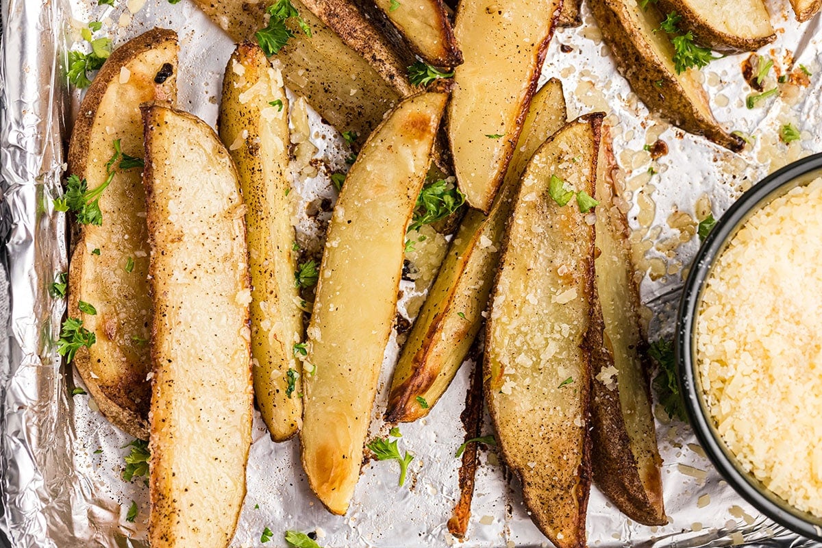 overhead shot of lined up parmesan truffle fries on a baking sheet