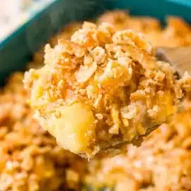 scoop of pineapple casserole on a serving spoon