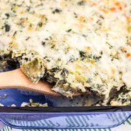 wooden spoon in spinach artichoke chicken casserole