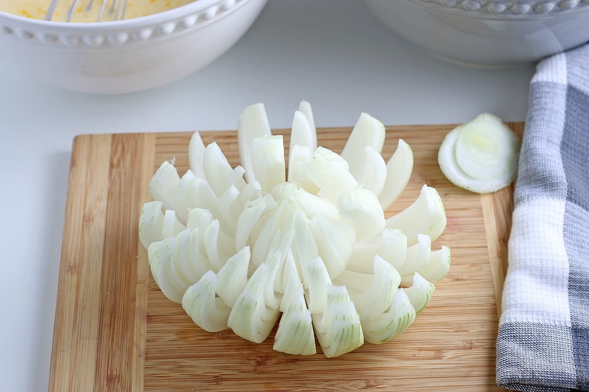 onion on cutting board cut into bloom