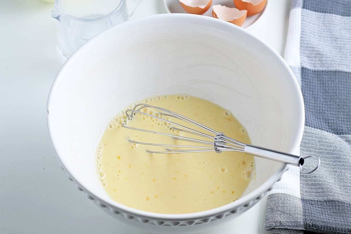 egg wash in bowl with whisk