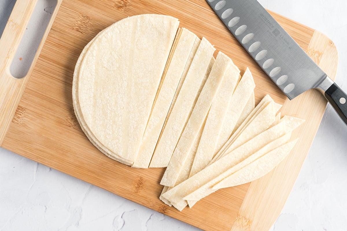 slicing corn tortillas for crispy tortillas strips