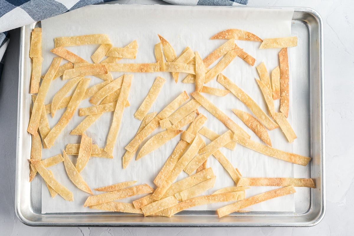 homemade tortillas strips on a baking sheet