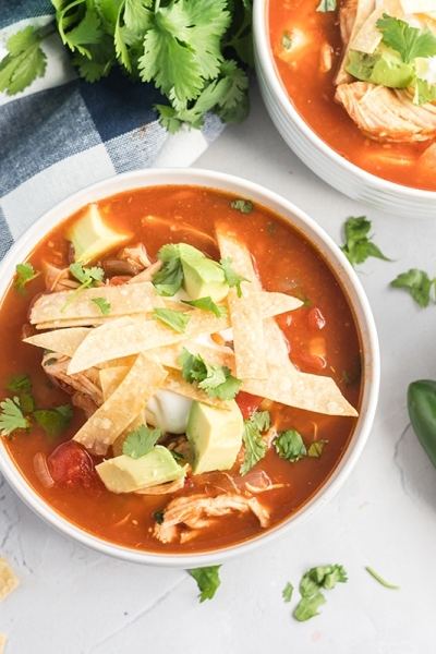 bowl of easy chicken tortilla soup with tortilla strips, avocado and cilantro