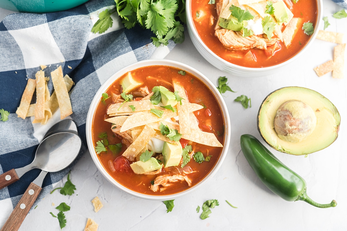 bowl of easy chicken tortilla soup with tortilla strips, avocado and cilantro