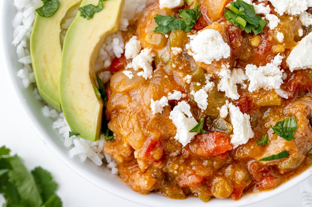 close up of pork chile verde in bowl with rice