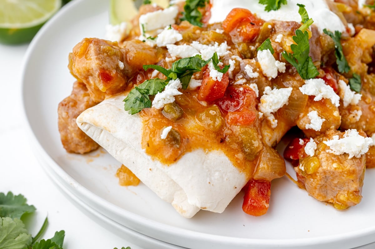 close up of pork chili verde over a burrito