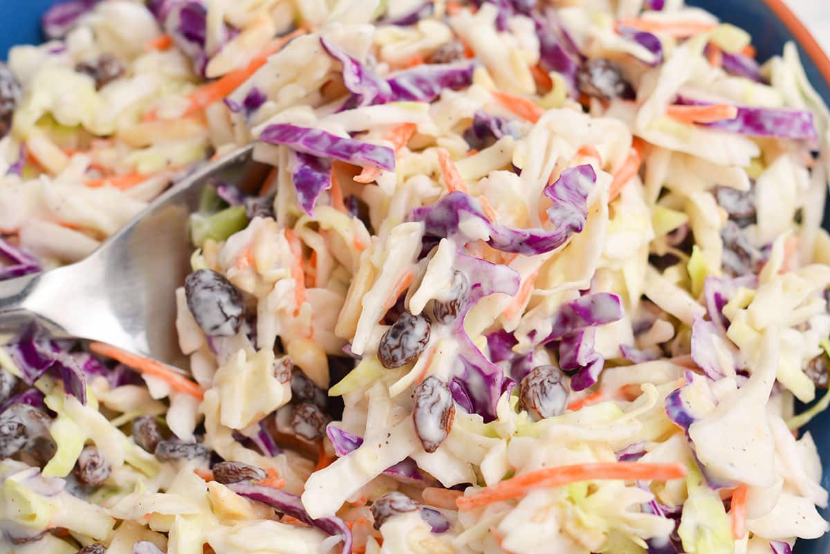 close up shot of creamy coleslaw on a spoon