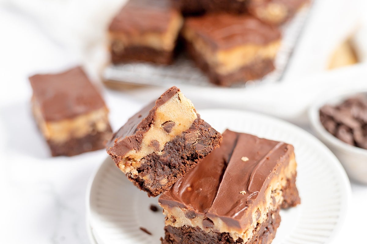 angled shot of two stacked cookie dough brownies