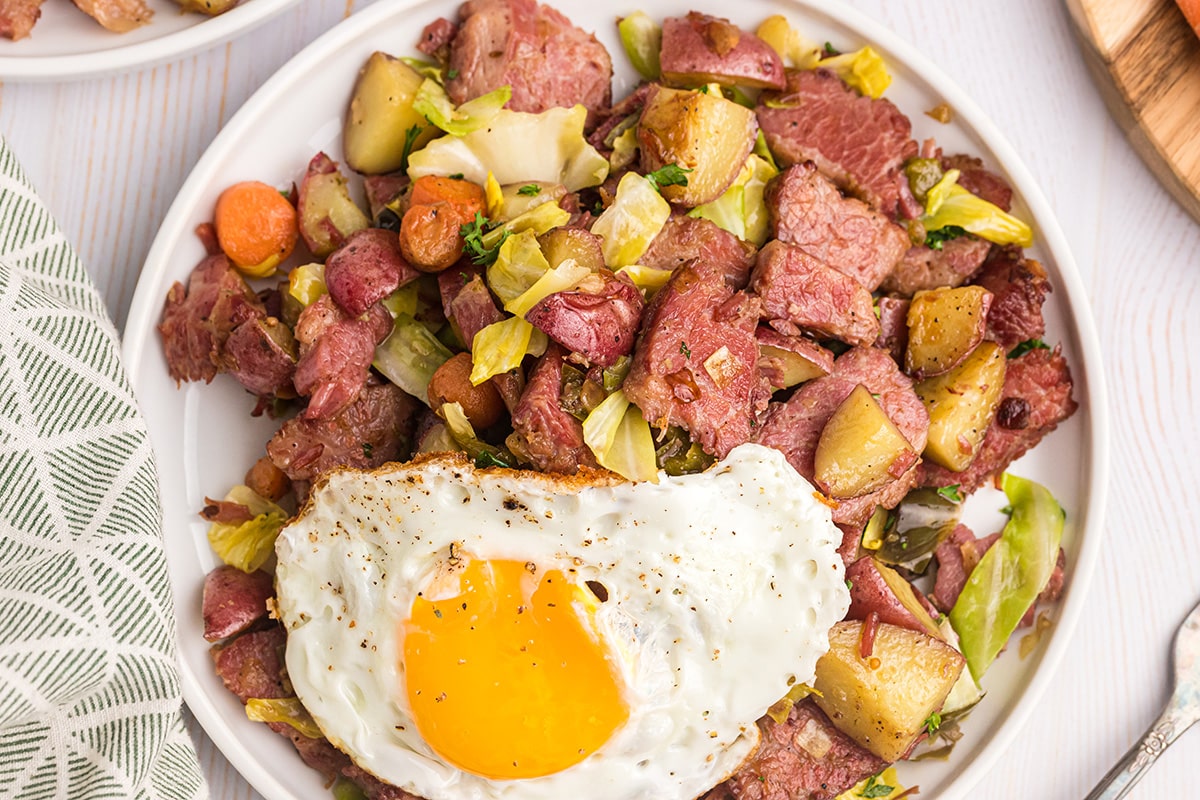 overhead shot of plate of corned beef hash with egg