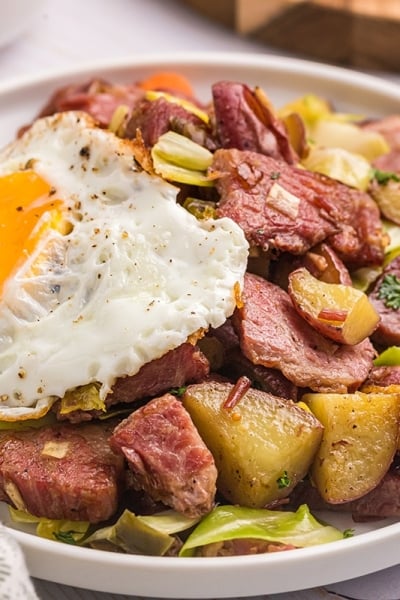 close up angled shot of corned beef hash with egg
