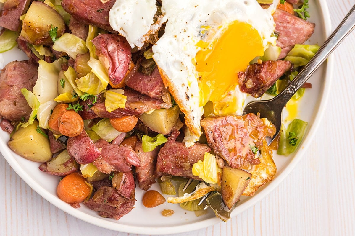 close up overhead shot of corned beef hash with an egg