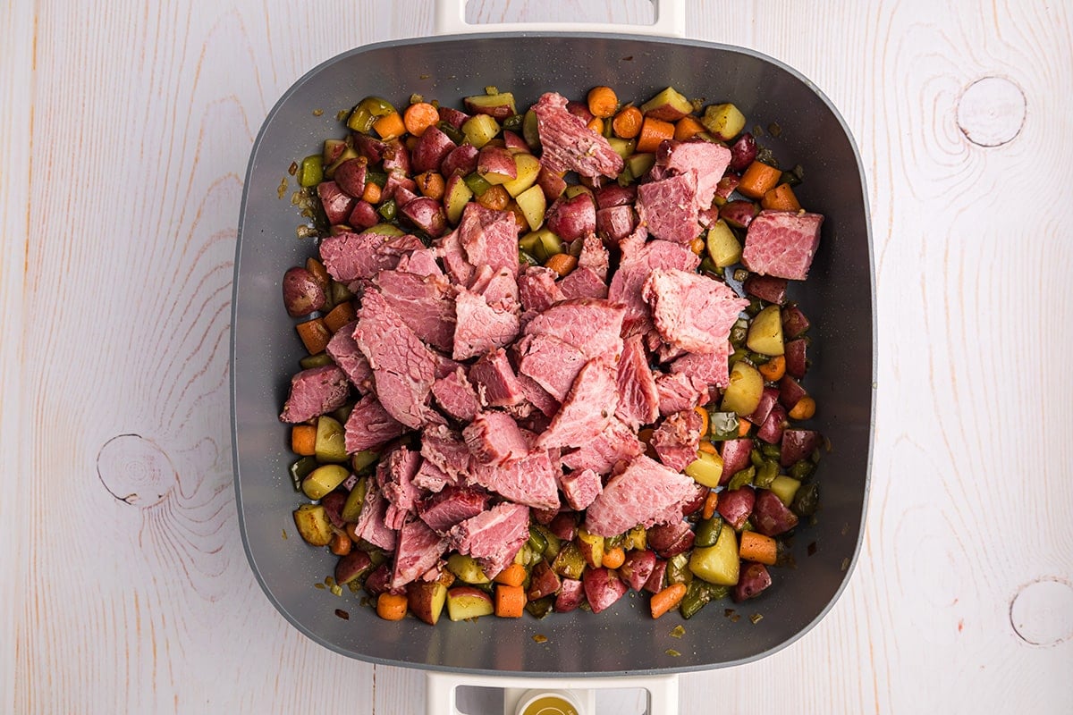 corned beef pieces added to skillet with veggies