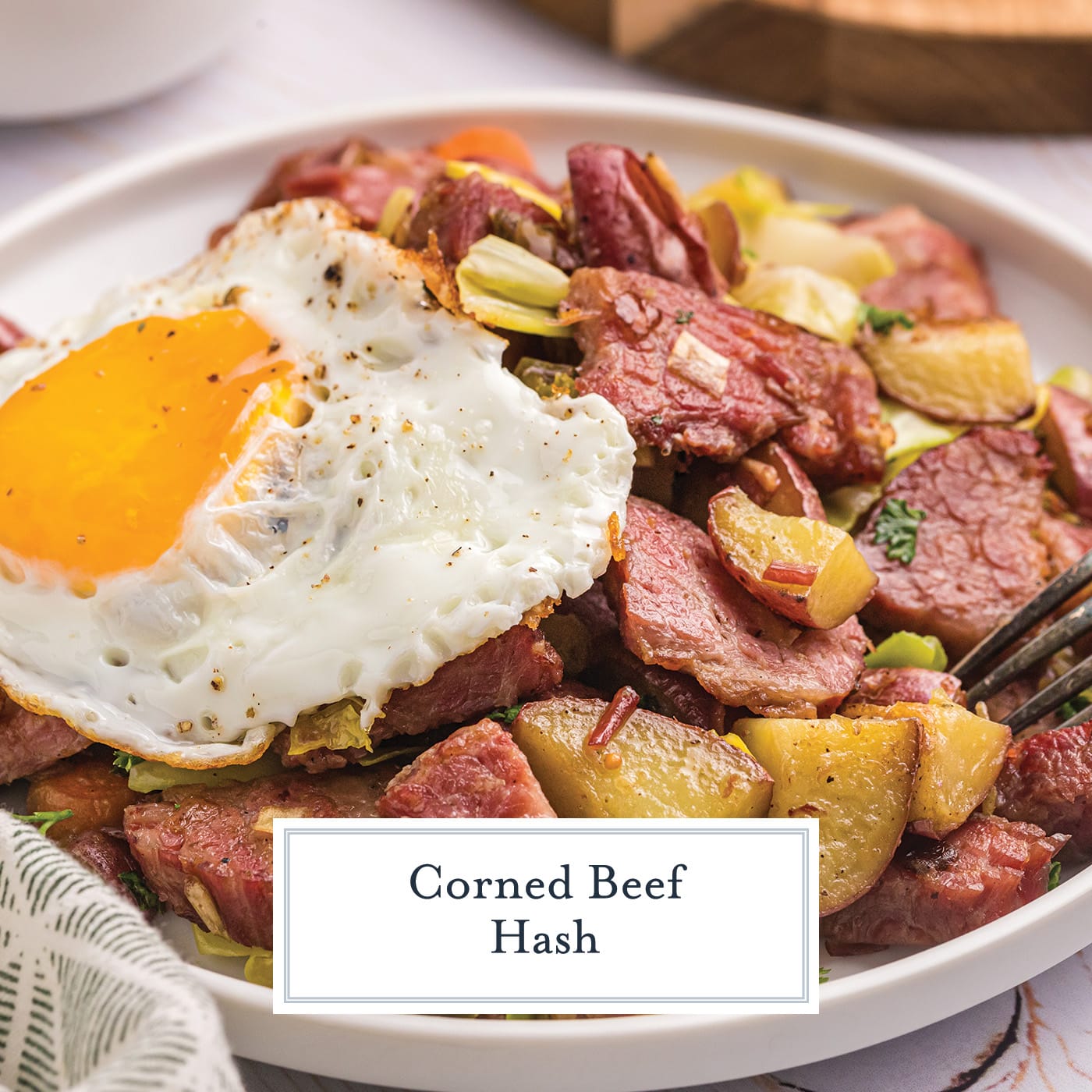 angled shot of egg on corned beef hash with text overlay for facebook