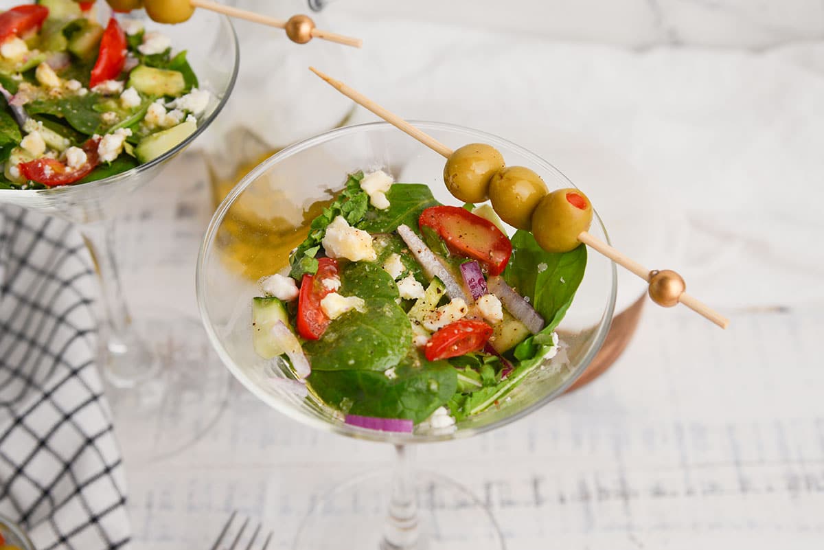 angled shot of salad in martini glass