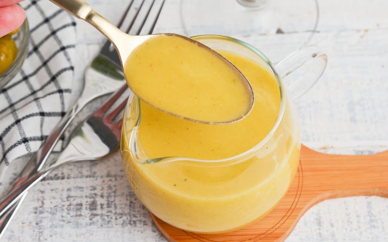 spoon in jar of dirty martini salad dressing