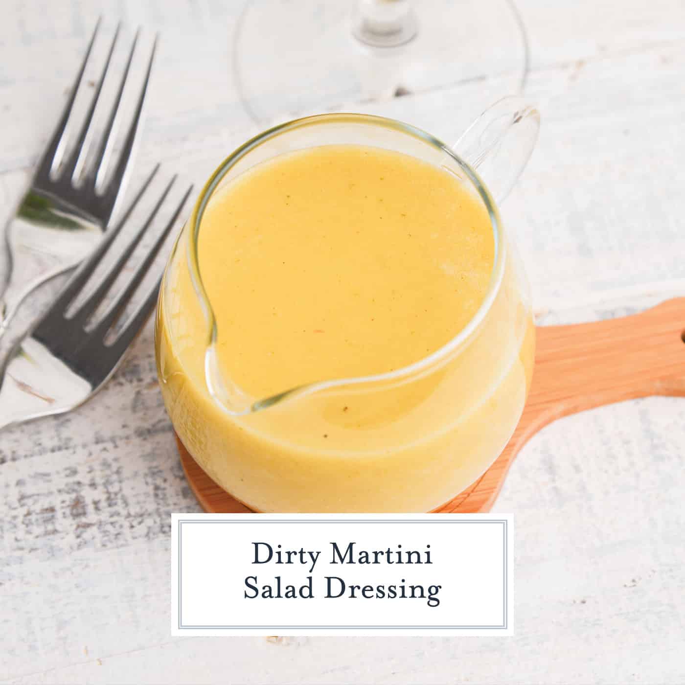 angled shot of dirty martini salad dressing in jar with text overlay for facebook