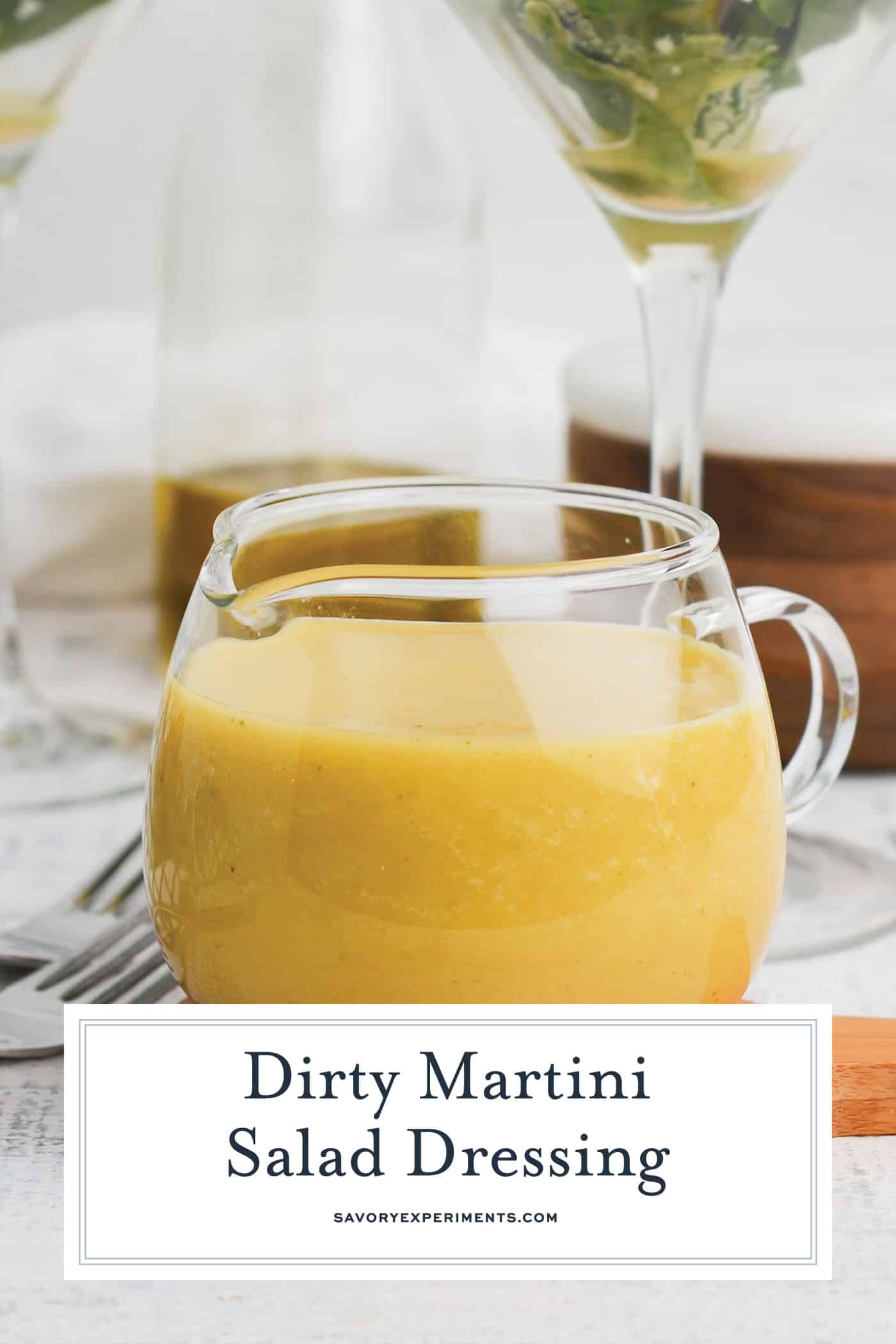 straight on shot of dirty martini dressing with text overlay for pinterest