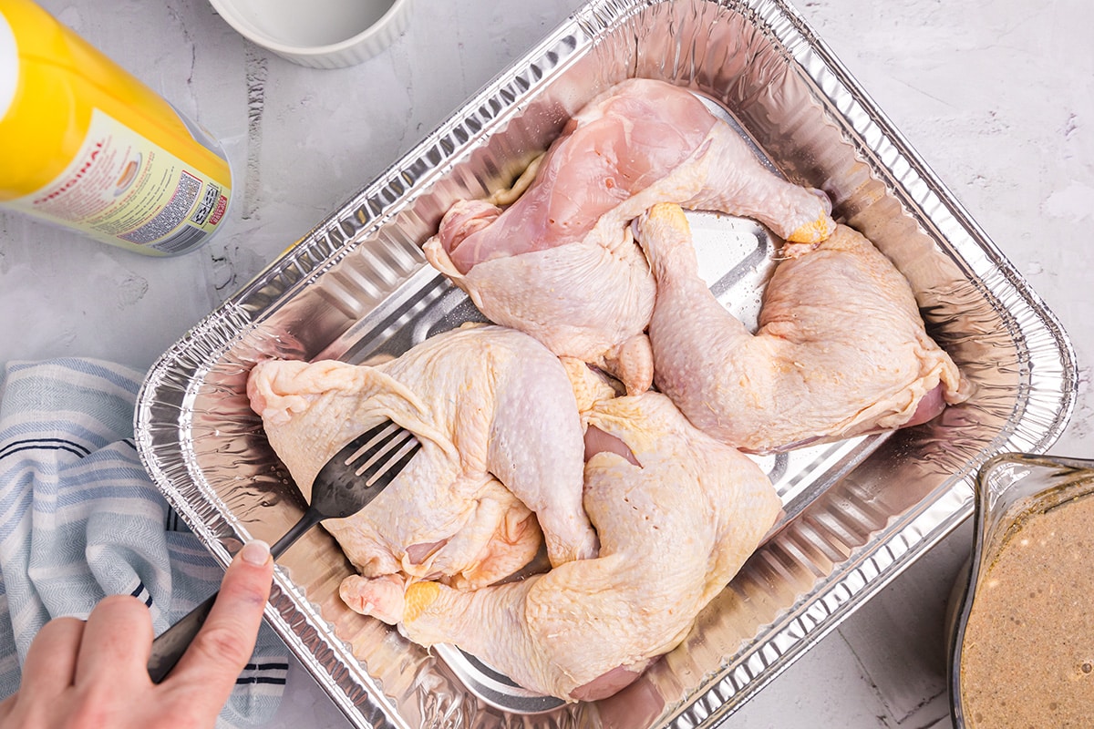 overhead shot of raw chicken in foil pan