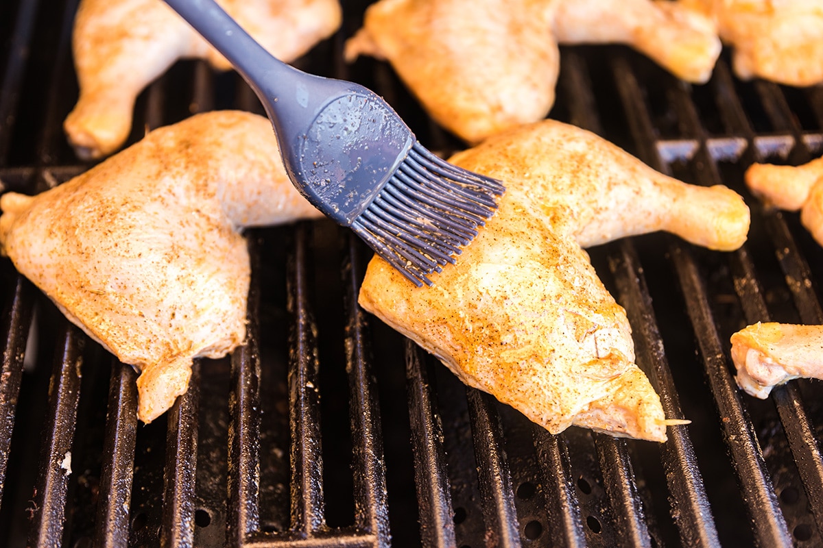 marinade brushed onto chicken on the grill