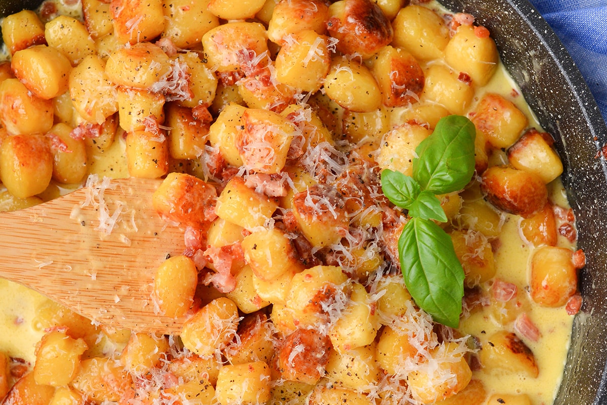 close up of gnocchi carbonara in a pan