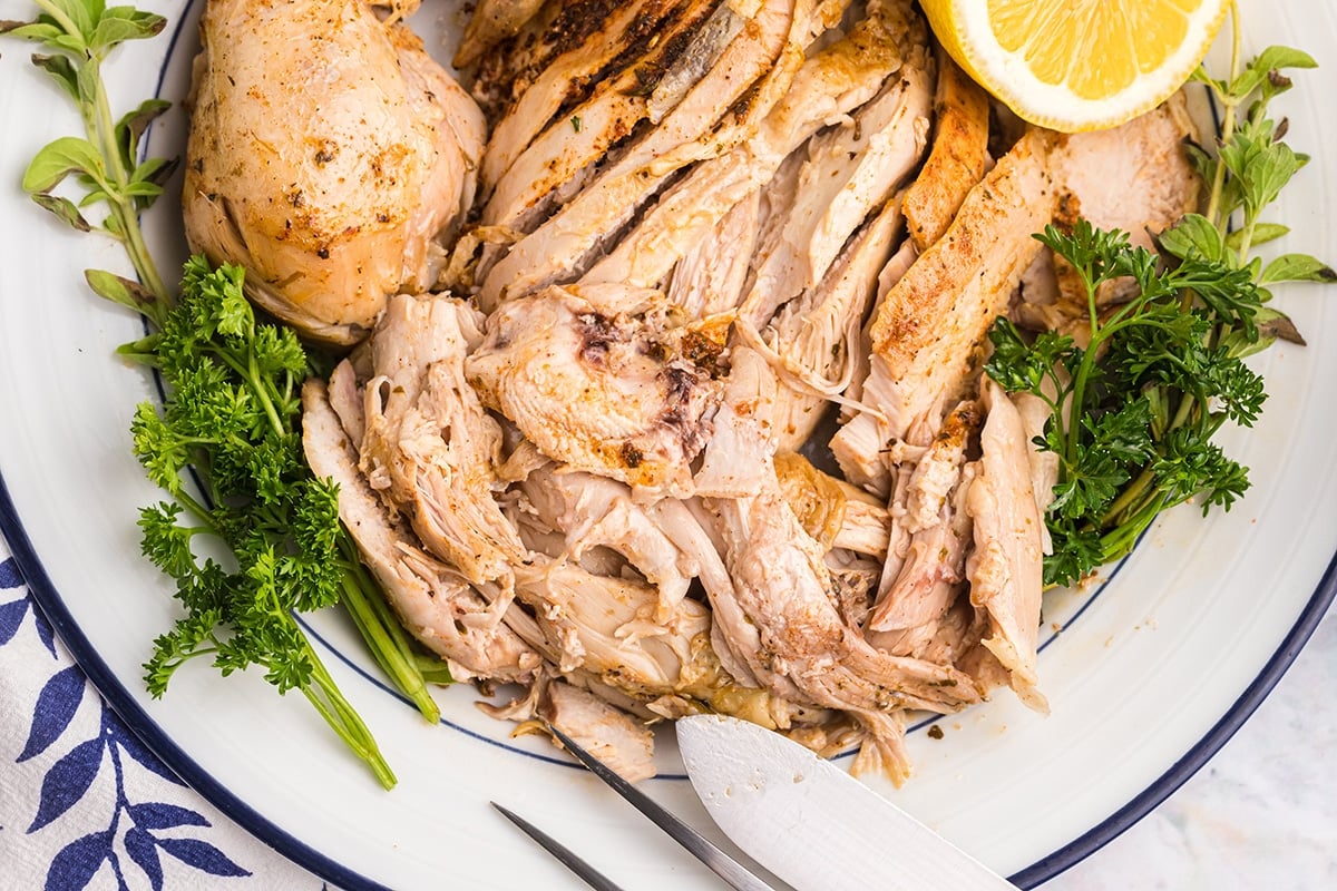 close up overhead shot of sliced instant pot whole chicken on a plate