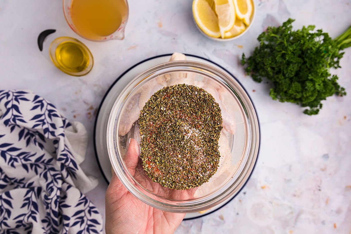 hand holding bowl of poultry seasoning