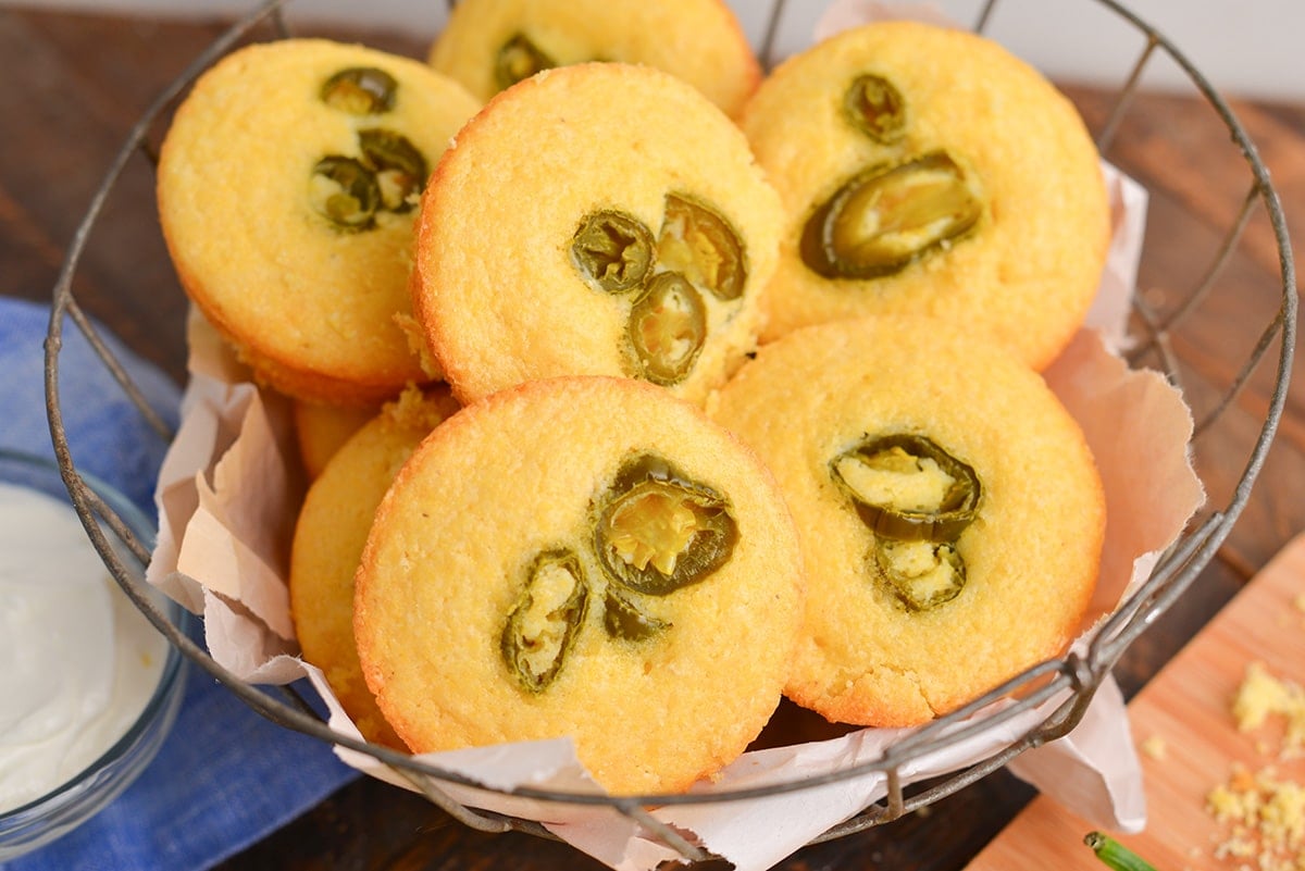 close up angled shot of basket of jalapeno cornbread muffins