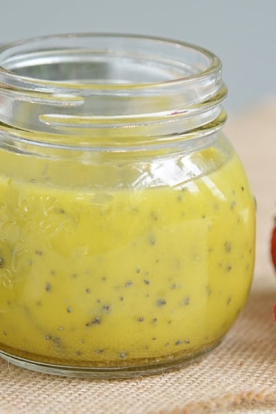 a jar of poppyseed dressing on burlap