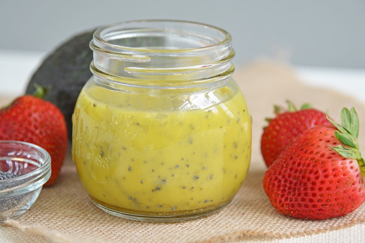 a jar of poppyseed dressing on burlap