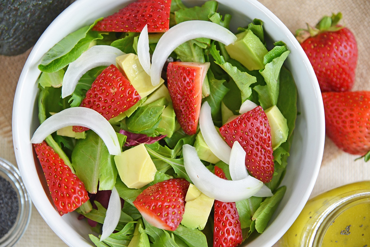 close up of salad with strawberries and avocado