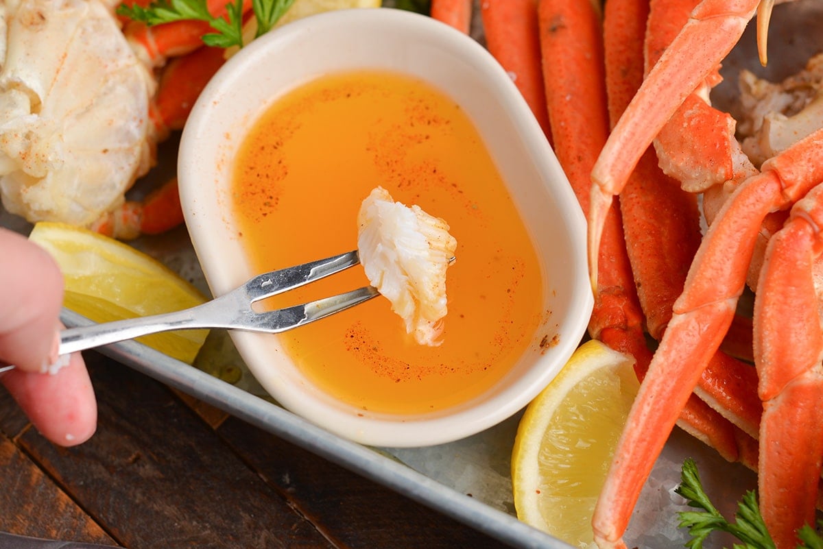 crab meat on fork dipped into butter