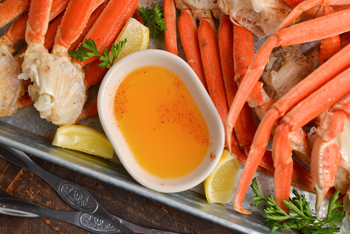 overhead shot of drawn butter with crab legs