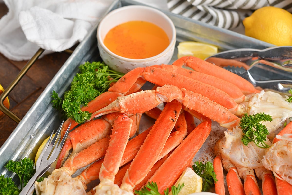 snow crab legs on tray with melted butter