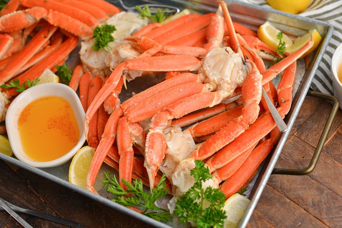 angled shot of snow crabs on tray with butter