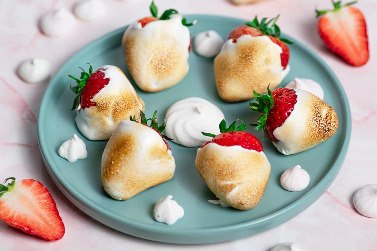 angled shot of plate of toasted marshmallow strawberries