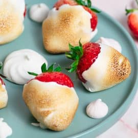 close up of toasted marshmallow strawberries on a plate