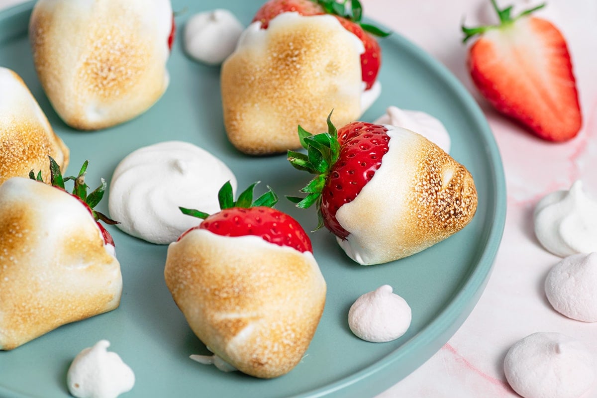 close up of toasted marshmallow strawberries on a plate