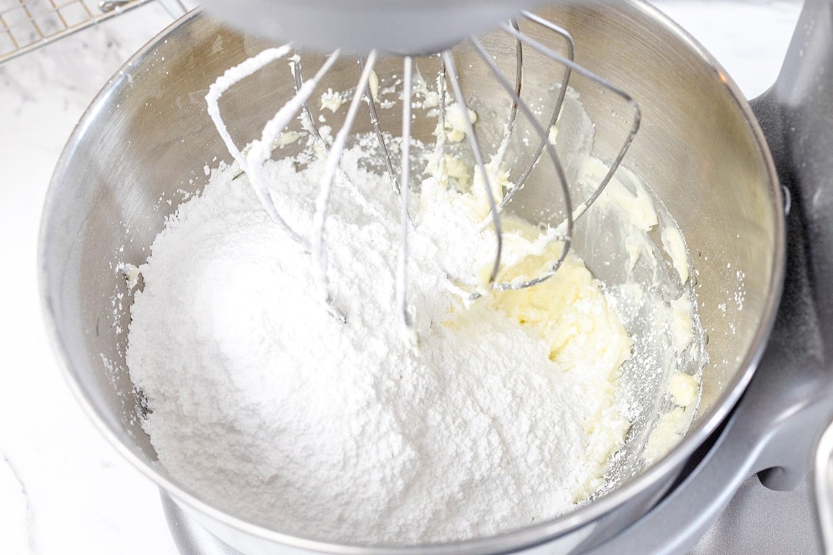 powdered sugar and butter in mixing bowl